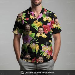 Man wearing custom Hawaiian shirt with black dog, pineapples, and bright flowers.