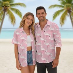 Bright pink flamingo aloha shirt with tropical bird pattern displayed on model in casual beach outfit