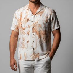 Male model in casual pose wearing Goose character inspired tropical Aloha shirt from Top Gun movie