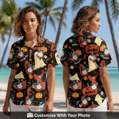 Woman wearing a Halloween shirt with black cat, pumpkins, bats, and witch hats print