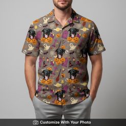 Man in Halloween Hawaiian shirt featuring black dog, ghosts, bats, and pumpkins