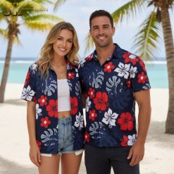 Young man wearing stars and stripes Aloha shirt at outdoor barbecue setting with American decorations visible