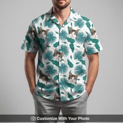 Man in Hawaiian Christmas shirt with white cat face and green palm frond pattern