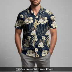 Man in black cat Hawaiian shirt featuring beige and blue tropical floral pattern
