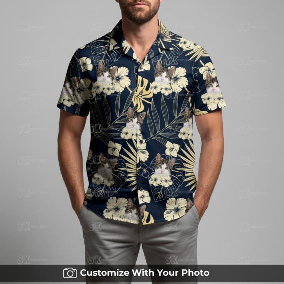 Man in black cat Hawaiian shirt featuring beige and blue tropical floral pattern