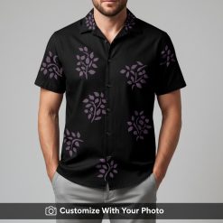 Man in classic black Hawaiian shirt with purple stylized leaf design, looking relaxed