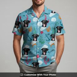 Man in blue Hawaiian shirt featuring fun black dog and vibrant sea-themed design