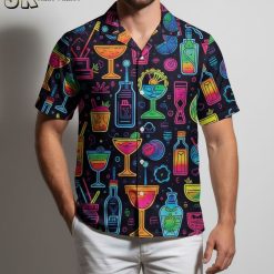 Male model in cocktail themed Aloha shirt standing outdoors in casual summer pose