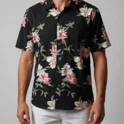 Man in Cooke Street Hawaiian shirt relaxing in beach chair with tropical background