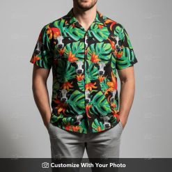 Man in a black cow print Hawaiian shirt with tropical green monstera leaves and flowers