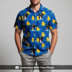 Man in custom blue Hawaiian shirt featuring black dogs and yellow rubber ducks design