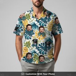Man in funny Hawaiian shirt with black dog, bold blue leaves, and yellow pineapples