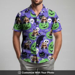 Man models Halloween Hawaiian shirt with purple, black, and green spooky designs