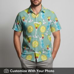 Man enjoying summer in a teal Hawaiian shirt with colorful cocktail glass patterns