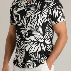 Guy modeling tropical pattern Aloha shirt outdoors in relaxed summer pose