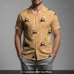 Man in vibrant orange Hawaiian shirt with face, cocktails, citrus and leaf pattern