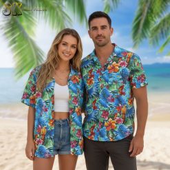 Man wearing mens parrot Hawaiian shirt sitting at outdoor tiki bar with tropical drinks