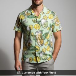 Man wearing tropical cocktail glass print Hawaiian shirt with citrus accents