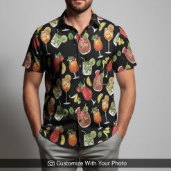 Man in tropical cocktail print Hawaiian shirt featuring drinks, orange, and mint