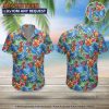 Man wearing colorful parrot Hawaiian shirt standing outdoors in casual beach pose
