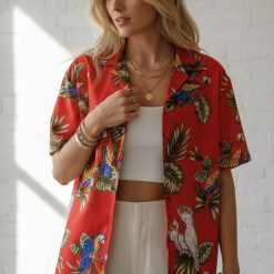 Size chart infographic showing parrot Hawaiian shirt measurements and fabric care instructions