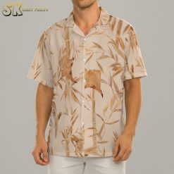 Man in relaxed pose wearing golden tropical print Aloha shirt, replicating Top Gun Rooster character outfit