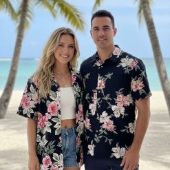 Male model standing outdoors wearing tropical print Cooke Street Hawaiian shirt with palm trees visible