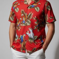 Close-up view of tropical parrot Aloha shirt showing detailed colorful bird pattern and button details