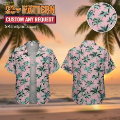 Woman wearing tropical print Hawaiian shirt with palm leaves and flowers in casual beach setting