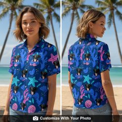 Woman modeling navy Hawaiian shirt with dog face, starfish, and seashell patterns outdoors