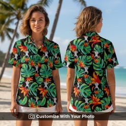 Woman wearing a black tropical cow Hawaiian shirt with green leaves and orange flowers