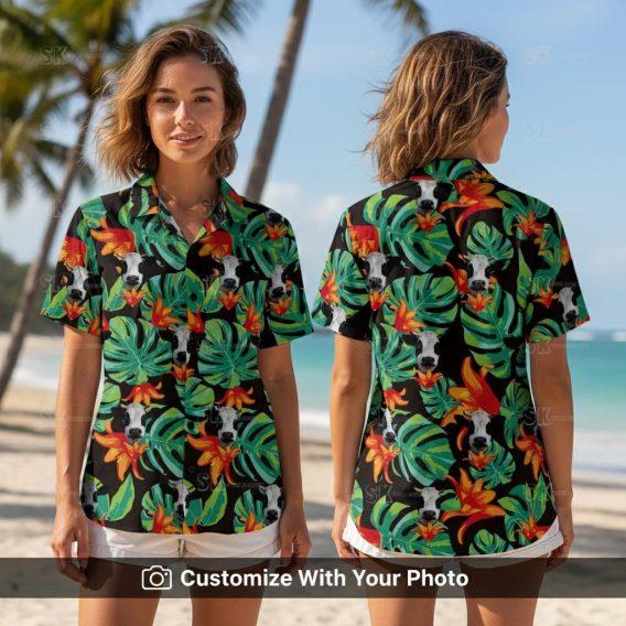 Woman wearing a black tropical cow Hawaiian shirt with green leaves and orange flowers