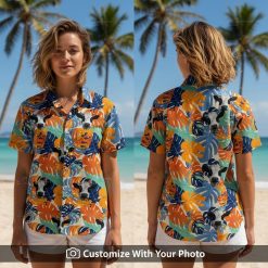 Woman wearing cow print Hawaiian shirt with orange, blue, and green tropical leaf design