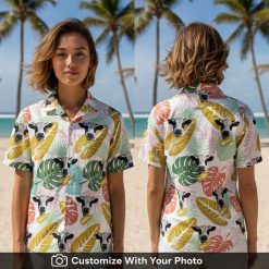 Woman wearing a vibrant cow print Hawaiian shirt with colorful tropical leaves outside