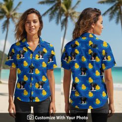 Woman wearing blue Hawaiian shirt with black dogs and yellow rubber ducks pattern