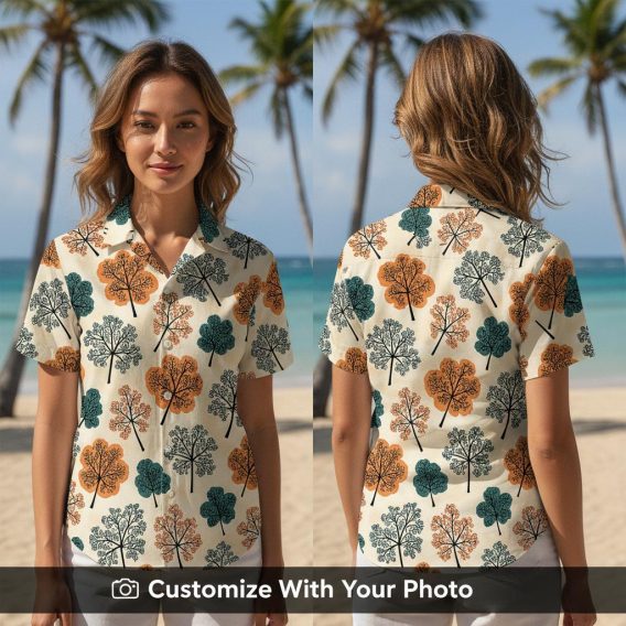 Woman wearing a bold floral Hawaiian shirt with orange and dark teal tree patterns