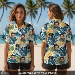 Woman wearing funny Hawaiian shirt featuring black dog, blue leaves, and pineapples