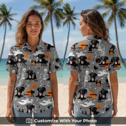Woman wearing Halloween aloha shirt with black dog, pumpkins, and bats design