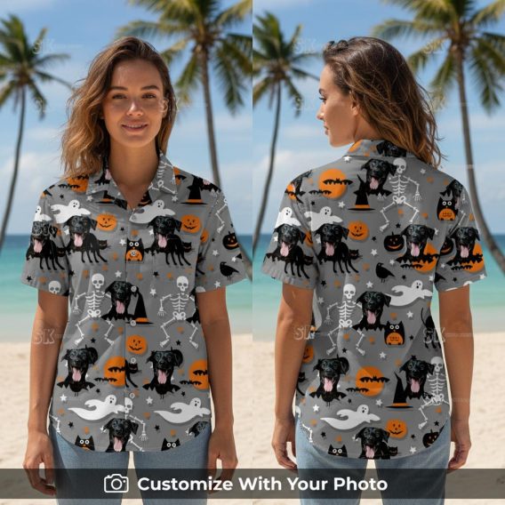 Woman wearing Halloween aloha shirt with black dog, pumpkins, and bats design