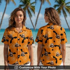 Woman wearing orange and black Hawaiian shirt with bats and spider webs for Halloween