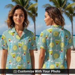 Woman wearing a summer cocktail pattern shirt with teal, yellow, and lime designs outdoors