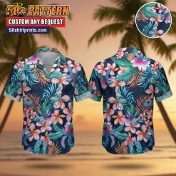 Woman wearing tropical print Hawaiian shirt with palm leaf pattern, standing on beach boardwalk