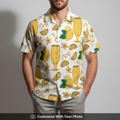 Man in yellow citrus Hawaiian shirt with lemon slices and cocktail glasses, beach vibes
