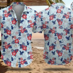 America 250 aloha shirt featuring red hibiscus, blue palm leaves, American flag, Statue of Liberty, Liberty Bell and eagle design