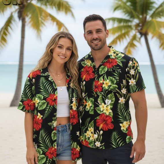 Black and white Hawaiian shirt displaying white plumeria flowers and green leaves on black fabric