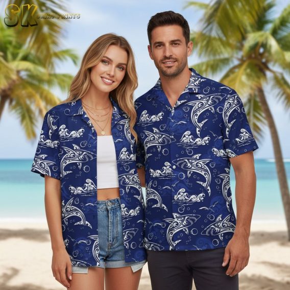 Blue aloha shirt displaying white dolphins with decorative line patterns surrounded by bubbles and wave designs