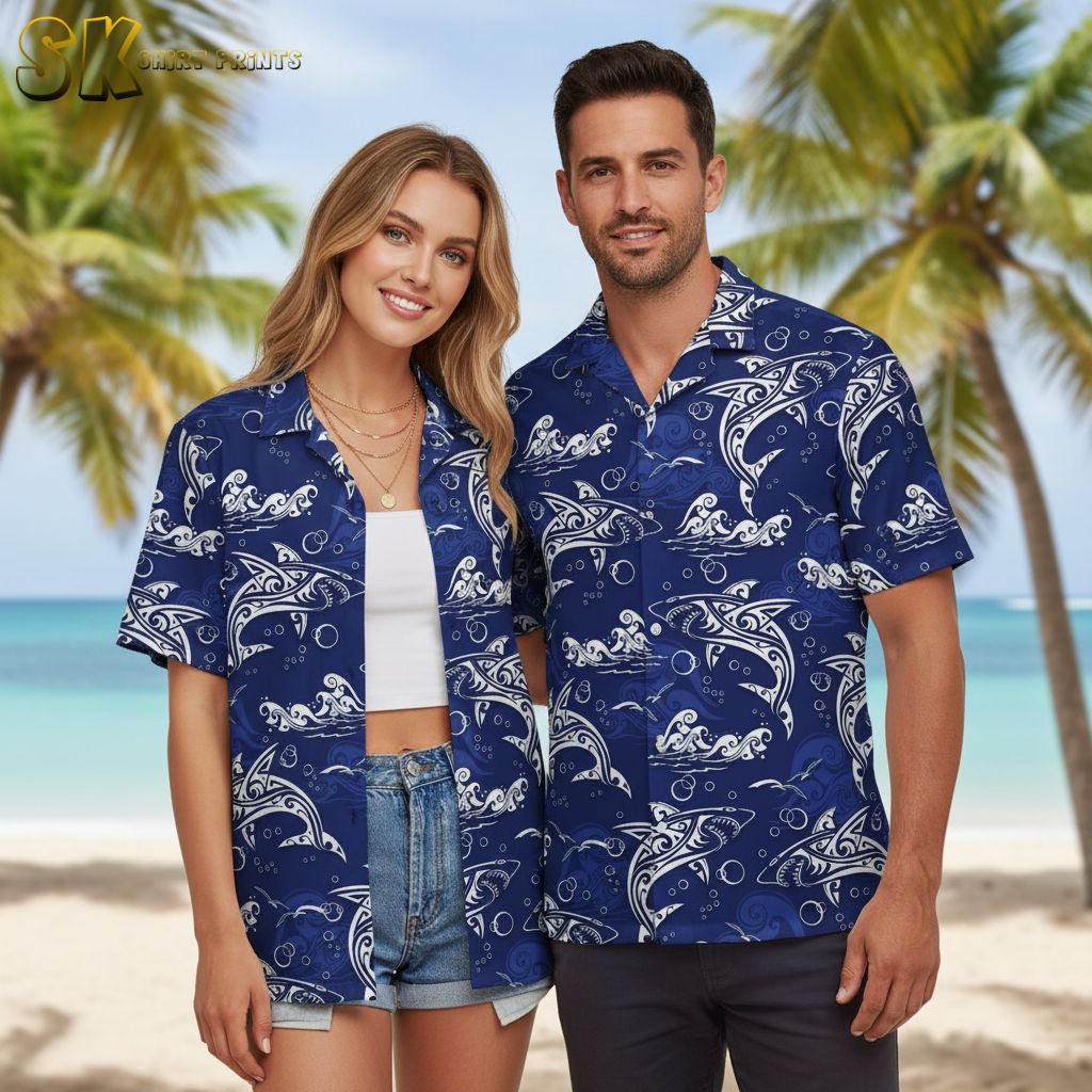 Blue aloha shirt displaying white dolphins with decorative line patterns surrounded by bubbles and wave designs