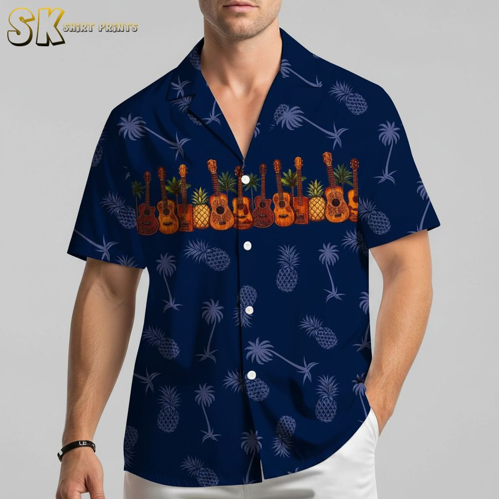 Blue aloha shirt displaying guitar and tropical fruit motifs against dark fabric