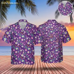 Blue and purple Hawaiian shirt featuring pink and yellow hibiscus flowers with green fern leaves and ukuleles on purple background