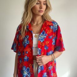 Full view of blue and red Hawaiian shirt showing complete floral design layout with hibiscus and tropical flowers